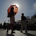 A woman with an umbrella walks at Plaza Puerta del Sol during a spring heatwave in Madrid, Spain, May 27, 2026. REUTERS/Kacper Pempel