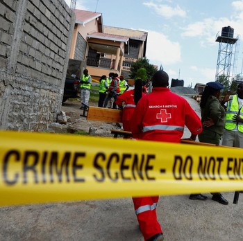 Members of the Kenya Red Cross walk towards the ruins of a burnt dormitory at the Utumishi Girls' Academy Senior School following an overnight fire at the facility in Gilgil, Nakuru county, Kenya May 28, 2026. REUTERS/Thomas Mukoya