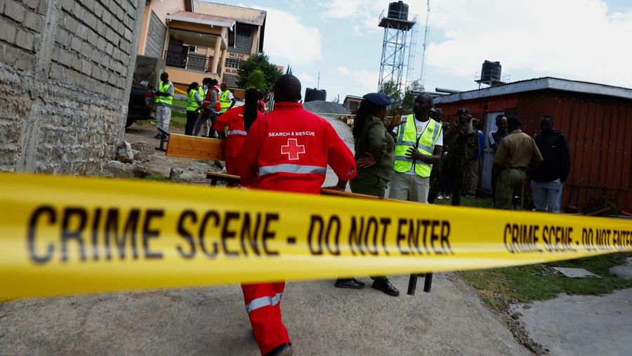 Members of the Kenya Red Cross walk towards the ruins of a burnt dormitory at the Utumishi Girls' Academy Senior School following an overnight fire at the facility in Gilgil, Nakuru county, Kenya May 28, 2026. REUTERS/Thomas Mukoya