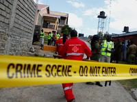 Members of the Kenya Red Cross walk towards the ruins of a burnt dormitory at the Utumishi Girls' Academy Senior School following an overnight fire at the facility in Gilgil, Nakuru county, Kenya May 28, 2026. REUTERS/Thomas Mukoya