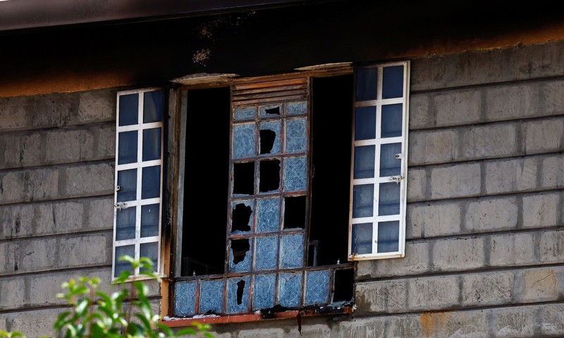 Members of the Kenya Red Cross walk towards the ruins of a burnt dormitory at the Utumishi Girls' Academy Senior School following an overnight fire at the facility in Gilgil, Nakuru county, Kenya May 28, 2026. REUTERS/Thomas Mukoya