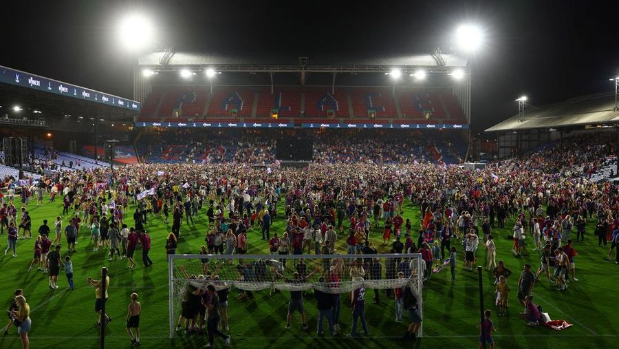 Soccer Football - UEFA Conference League - Final - Fans gather to watch Crystal Palace v Rayo Vallecano - Selhurst Park, London, Britain - May 27, 2026 Crystal Palace fans celebrate on the pitch after winning the UEFA Conference League final Action I