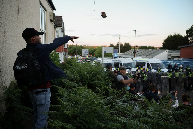 Para pengunjuk rasa berdiri menghadap petugas polisi selama demonstrasi menyusul vonis terhadap Vikrum Digwa atas pembunuhan mahasiswa Henry Nowak, di Southampton, Inggris, 2 Juni 2026. (REUTERS/Isabel Infantes)