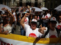 Orang-orang meneriakkan slogan-slogan selama demonstrasi pada hari serikat pekerja utama Portugal, CGTP, menyerukan pemogokan umum sebagai protes terhadap rencana pemerintah untuk mereformasi undang-undang ketenagakerjaan, di Lisbon, Portugal, 3 Juni