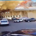 Rekaman CCTV menunjukkan sebuah mobil meninggalkan tempat parkir saat api dan asap mengepul setelah serangan di Bandara Internasional Kuwait di Kota Kuwait, Kuwait, 3 Juni 2026, dalam cuplikan video ini. (Civil Aviation Kuwait/Handout via REUTERS)