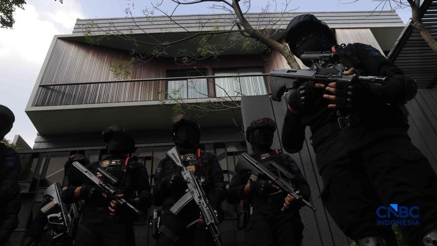 Sejumlah petugas kepolisian dari Brimob bersenjata laras panjang berjaga tepat di depan pagar pintu masuk saat penyidik Komisi Pemberantasan Korupsi (KPK) mendatangi kediaman pribadi Wakil Menteri Imigrasi dan Pemasyarakatan (Wamen Imipas) Silmy Kari