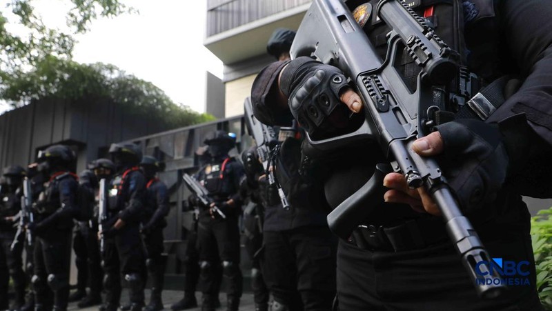 Sejumlah petugas kepolisian dari Brimob bersenjata laras panjang berjaga tepat di depan pagar pintu masuk saat penyidik Komisi Pemberantasan Korupsi (KPK) mendatangi kediaman pribadi Wakil Menteri Imigrasi dan Pemasyarakatan (Wamen Imipas) Silmy Kari
