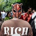 A person wears a cockroach themed mask, as supporters of the Cockroach Janta Party (CJP) await the arrival of Abhijeet Dipke, head of the CJP, on the day of a sit-in protest demanding the resignation of Indian Education Minister Dharmendra Pradhan, i