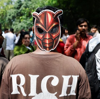 A person wears a cockroach themed mask, as supporters of the Cockroach Janta Party (CJP) await the arrival of Abhijeet Dipke, head of the CJP, on the day of a sit-in protest demanding the resignation of Indian Education Minister Dharmendra Pradhan, i
