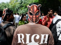 A person wears a cockroach themed mask, as supporters of the Cockroach Janta Party (CJP) await the arrival of Abhijeet Dipke, head of the CJP, on the day of a sit-in protest demanding the resignation of Indian Education Minister Dharmendra Pradhan, i