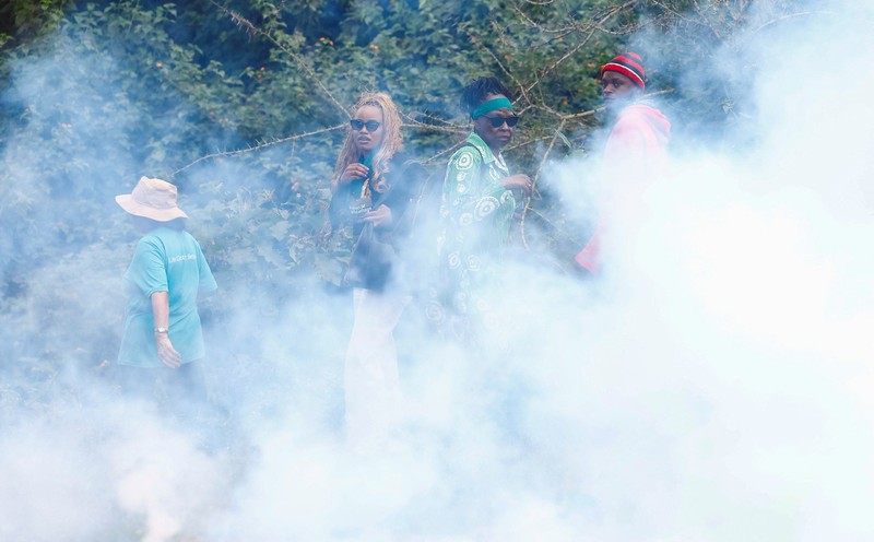 Para aktivis lingkungan bubar setelah petugas polisi anti huru hara melemparkan tabung gas air mata ke arah mereka selama demonstrasi menentang pengarahan lahan Taman Nasional Nairobi dan rencana relokasi Panti Asuhan Hewan Nairobi di Nairobi, Kenya, 8 Juni 2026. (REUTERS/Monicah Mwangi)