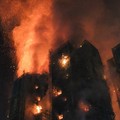 Thick smoke and flames rise as a major fire engulfs several apartment blocks at the Wang Fuk Court residential estate in Hong Kong's Tai Po district on November 26, 2025. At least four people were killed when a fire engulfed several high-rise blocks
