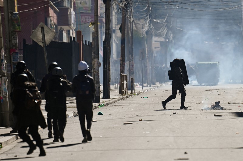 Para petugas polisi berjaga-jaga selama demonstrasi yang menyerukan pengunduran diri Presiden Bolivia Rodrigo Paz, menyusul protes dan blokade selama berminggu-minggu yang menyebabkan kekurangan makanan, bahan bakar, dan obat-obatan, di La Paz, Bolivia, 10 Juni 2026. (REUTERS/Claudia Morales)