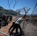 Para pengunjuk rasa yang mengatakan tanah mereka telah diambil secara tidak adil, merobohkan pagar tempat resor wisata akan dibangun di tepi pantai Adriatik, di Rrjoll, dekat Shkodra, Albania, 13 Juni 2026. (REUTERS/Florion Goga)