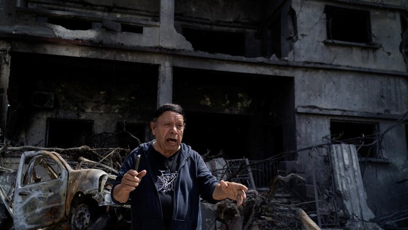 Youssef Fares, 90, shouts in frustration as he stands in front of his bombed home of more than 70 years, damaged in an Israeli airstrike, following a deal between the U.S. and Iran, in Tyre, southern Lebanon, June 16, 2026. REUTERS/Zohra Bensemra.