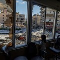 A displaced girl stands at the broken window of Jabal Amel hospital where she has taken shelter with her family, overlooking buildings damaged by Israeli strikes, following a deal between the U.S. and Iran, in Tyre, southern Lebanon, June 16, 2026. R