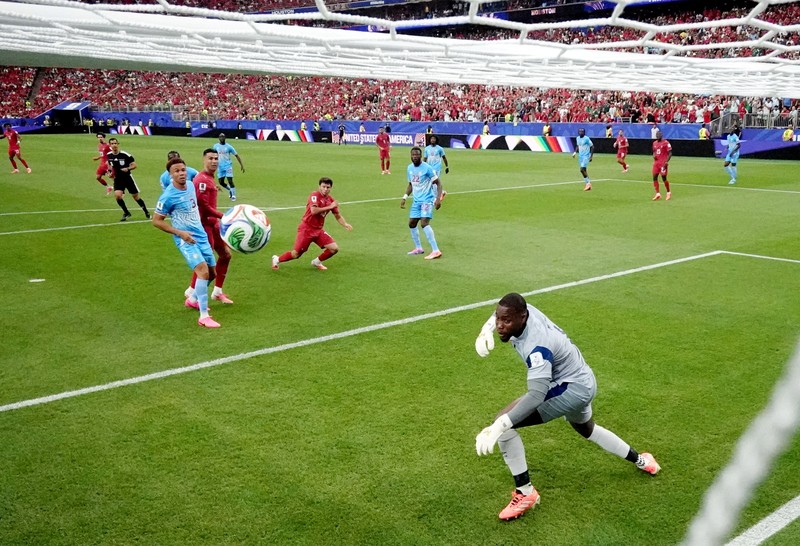 Soccer Football - FIFA World Cup 2026 - Group K - Portugal v DR Congo - Houston Stadium, Houston, Texas, U.S. - June 17, 2026 DR Congo's Edo Kayembe in action with Portugal's Nuno Mendes REUTERS/Pedro Nunes