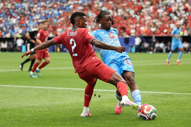 Soccer Football - FIFA World Cup 2026 - Group K - Portugal v DR Congo - Houston Stadium, Houston, Texas, U.S. - June 17, 2026 DR Congo's Edo Kayembe in action with Portugal's Nuno Mendes REUTERS/Pedro Nunes