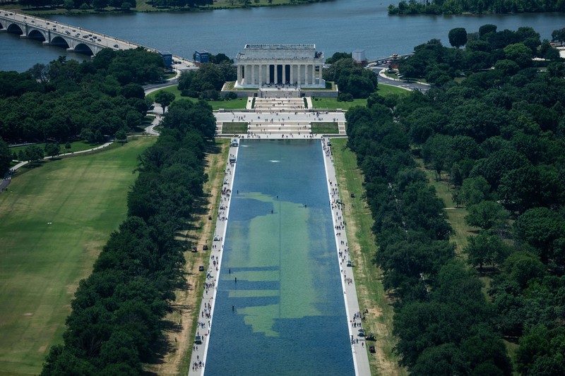 Petugas kebersihan menguras sebagian besar air di Kolam Refleksi Monumen Lincoln di Amerika Serikat setelah diduga menjadi objek tindakan vandalisme pada Minggu (21/6/2026). (REUTERS/Aaron Schwartz)