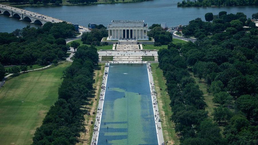 Petugas kebersihan menguras sebagian besar air di Kolam Refleksi Monumen Lincoln di Amerika Serikat setelah diduga menjadi objek tindakan vandalisme pada Minggu (21/6/2026). (REUTERS/Aaron Schwartz)