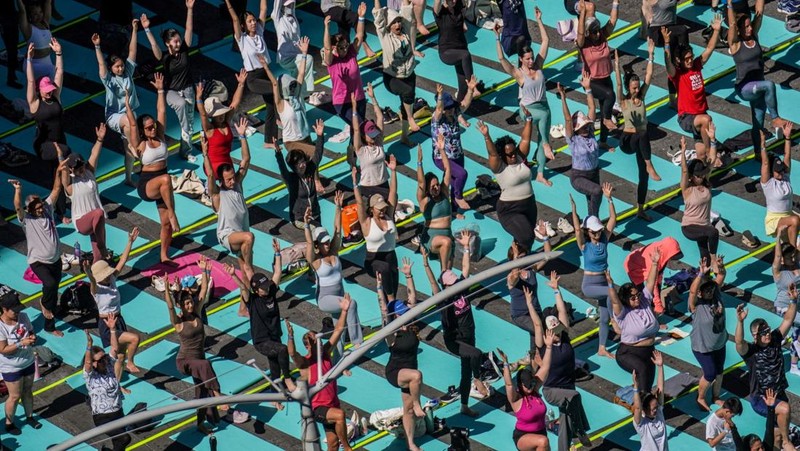 Para yogi mengikuti kelas yoga selama acara tahunan ke-24