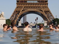 Orang-orang mendinginkan diri di Air Mancur Trocadero di sebelah Menara Eiffel saat suhu meningkat selama gelombang panas yang melanda sebagian besar negara, di Paris, Prancis, 22 Juni 2026. (REUTERS/Abdul Saboor)