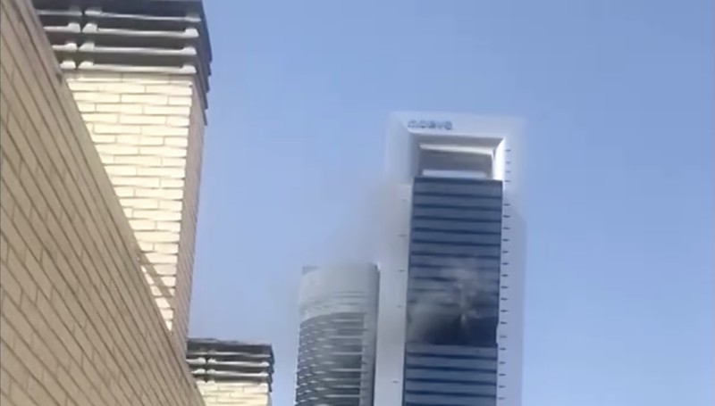 Kebakaran yang terjadi di sebuah gedung pencakar langit di Madrid, Spanyol, pada Selasa (23/6/2026) siang berhasil dikendalikan dan tidak menimbulkan korban luka. (Tangkapan Layar Video Reuters/@MANDY84104473 VIA X)