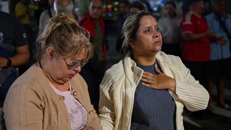 Astrid Espinoza dan Noemi Cordoba, ibu dan nenek dari Shantal Quintero, 18 tahun, menunggu di lokasi bangunan yang runtuh, sementara petugas darurat mencarinya, setelah gempa bumi, di Caracas, Venezuela, 25 Juni 2026.