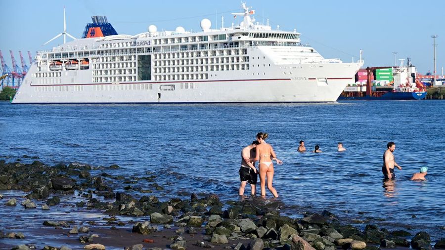Orang-orang menikmati kesejukan air Sungai Elbe saat sebuah kapal pesiar meninggalkan pelabuhan di Hamburg, Jerman, 26 Juni 2026. (REUTERS/Fabian Bimmer)