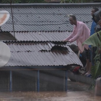 A person wades through floodwaters, in Accra, Ghana, in this still image taken from a video, June 29, 2026. Reuters TV via REUTERS