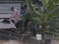 A person wades through floodwaters, in Accra, Ghana, in this still image taken from a video, June 29, 2026. Reuters TV via REUTERS