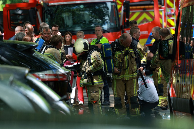 Para petugas penyelamat bekerja di lokasi kebakaran di sebuah gedung perumahan di Antwerp, Belgia, 1 Juli 2026. (REUTERS/Yves Herman)