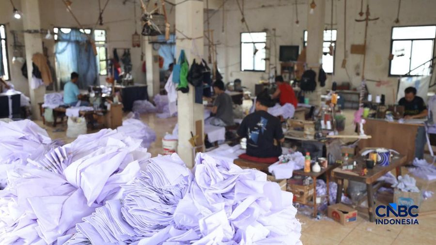 Pekerja menyelesaikan produksi pakain sekolah di konveksi rumahan kawasan Jakarta, Jumat (3/7/2026).