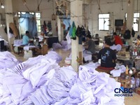 Pekerja menyelesaikan produksi pakain sekolah di konveksi rumahan kawasan Jakarta, Jumat (3/7/2026). (CNBC Indonesia/Tri Susilo)