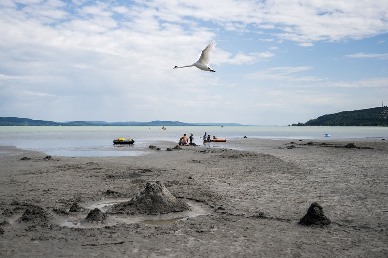 A drone view shows people walking on an exposed sandbank locally known as
