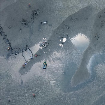 A drone view shows people walking on an exposed sandbank locally known as "Monkey Island" that has reappeared as Lake Balaton's water level drops, in Balatonfenyves, Hungary, July 5, 2026. REUTERS/Marton Monus