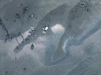 A drone view shows people walking on an exposed sandbank locally known as "Monkey Island" that has reappeared as Lake Balaton's water level drops, in Balatonfenyves, Hungary, July 5, 2026. REUTERS/Marton Monus