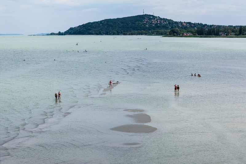 A drone view shows people walking on an exposed sandbank locally known as