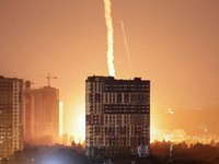 An explosion lights up the sky over the city during a Russian missile and drone strike, amid Russia's attack on Ukraine, in Kyiv, Ukraine July 6, 2026. REUTERS/Vladyslav Sodel
