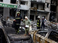 Rescuers assist residents as they evacuate an apartment building, which was heavily damaged during Russian missile and drone strikes, amid Russia's attack on Ukraine, in Kyiv, Ukraine, July 6, 2026. REUTERS/Valentyn Ogirenko