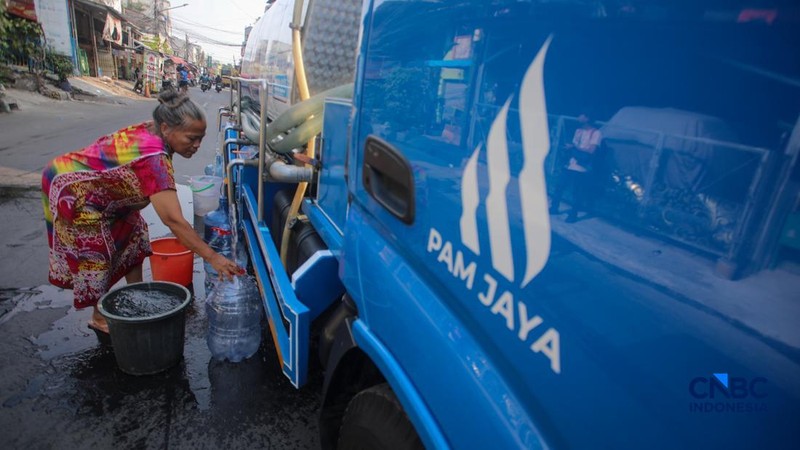 Warga mengambil air bersih dari mobil layanan bantuan air bersih di Jalan H Mawar, Sunter Jaya, Tanjung Priok, Jakarta Utara, Senin (6/7/2026).