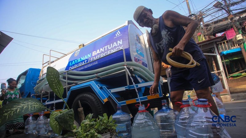 Warga mengambil air bersih dari mobil layanan bantuan air bersih di Jalan H Mawar, Sunter Jaya, Tanjung Priok, Jakarta Utara, Senin (6/7/2026).