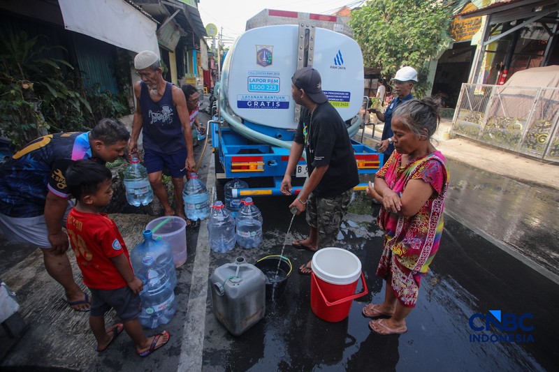 Warga mengambil air bersih dari mobil layanan bantuan air bersih di Jalan H Mawar, Sunter Jaya, Tanjung Priok, Jakarta Utara, Senin (6/7/2026). (CNBC Indonesia/Faisal Rahman)