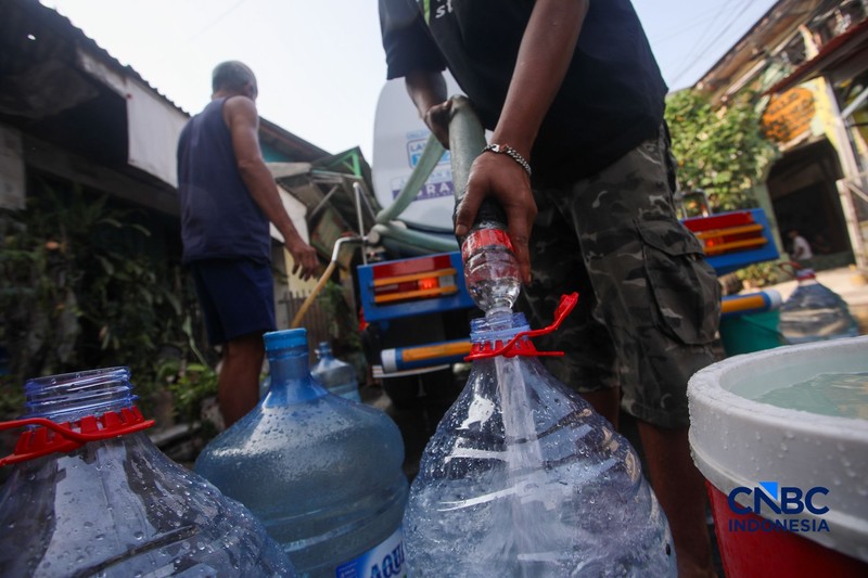 Warga mengambil air bersih dari mobil layanan bantuan air bersih di Jalan H Mawar, Sunter Jaya, Tanjung Priok, Jakarta Utara, Senin (6/7/2026). (CNBC Indonesia/Faisal Rahman)
