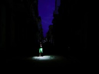 A man uses his phone's flashlight to light his way while walking on a street as Cuba's national electric grid collapsed at midday, leaving around 10 million people without power, in Havana, Cuba, July 6, 2026. REUTERS/Norlys Perez