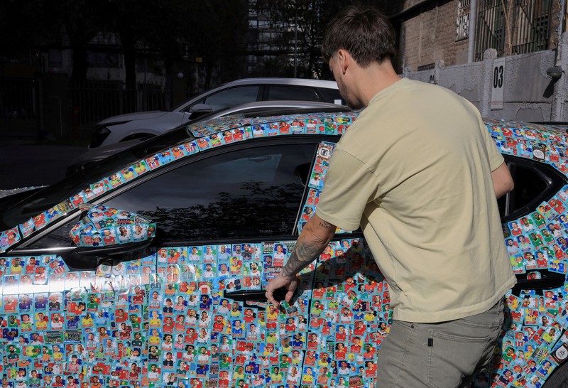 Chilean soccer fan and content creator Ariel Osses smiles while sitting in his car, which is covered with FIFA World Cup 2026 Panini stickers, fulfilling an updated version of his childhood dream of having a World Cup Panini album, in Santiago, Chile, July 6, 2026. REUTERS/Diego Reyes     TPX IMAGES OF THE DAY
