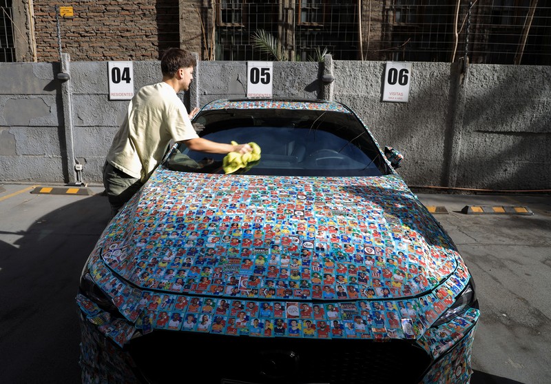 Chilean soccer fan and content creator Ariel Osses smiles while sitting in his car, which is covered with FIFA World Cup 2026 Panini stickers, fulfilling an updated version of his childhood dream of having a World Cup Panini album, in Santiago, Chile, July 6, 2026. REUTERS/Diego Reyes     TPX IMAGES OF THE DAY