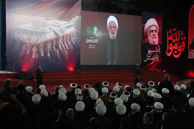 People carry the coffin of Iran's late Supreme Leader Ayatollah Ali Khamenei, who was killed on February 28 in Israeli and U.S. airstrikes, after it was unloaded from a refrigeration vehicle, during his funeral procession, in Karbala, Iraq, July 9, 2026. REUTERS/Ahmed Saad