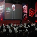 Hezbollah chief Naim Qassem is displayed on a screen as people gather to mourn Iran's late Supreme Leader Ayatollah Ali Khamenei, who was killed on February 28 in Israeli and U.S. airstrikes, in the southern suburbs of Beirut, Lebanon, July 8, 2026.