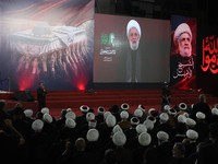 Hezbollah chief Naim Qassem is displayed on a screen as people gather to mourn Iran's late Supreme Leader Ayatollah Ali Khamenei, who was killed on February 28 in Israeli and U.S. airstrikes, in the southern suburbs of Beirut, Lebanon, July 8, 2026.